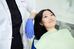 https://www.pexels.com/photo/a-woman-on-a-dental-chair-7803063/ Woman in a dental chair smiling learning about dental implants