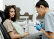 Photo by Cedric Fauntleroy: https://www.pexels.com/photo/dentist-with-patient-4269369/ A periodontist and a female patient discussing all-on-4 procedure steps
